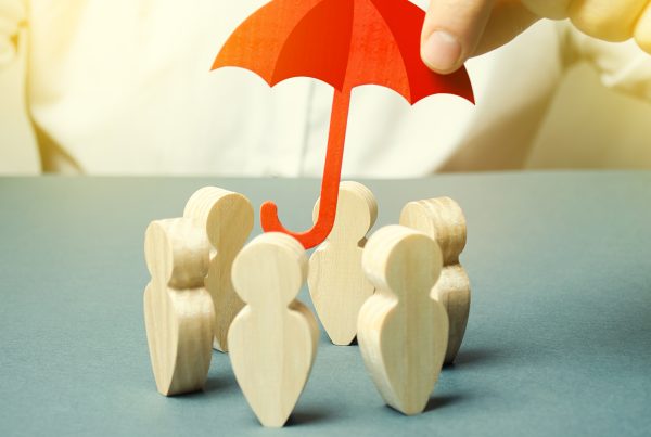 umbrella held over wooden figures