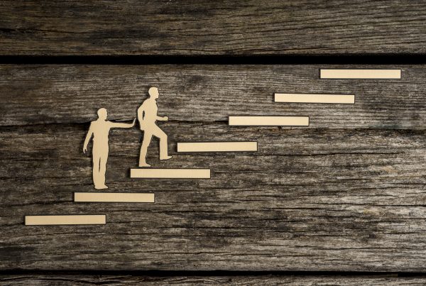 cut-outs of people climbing steps