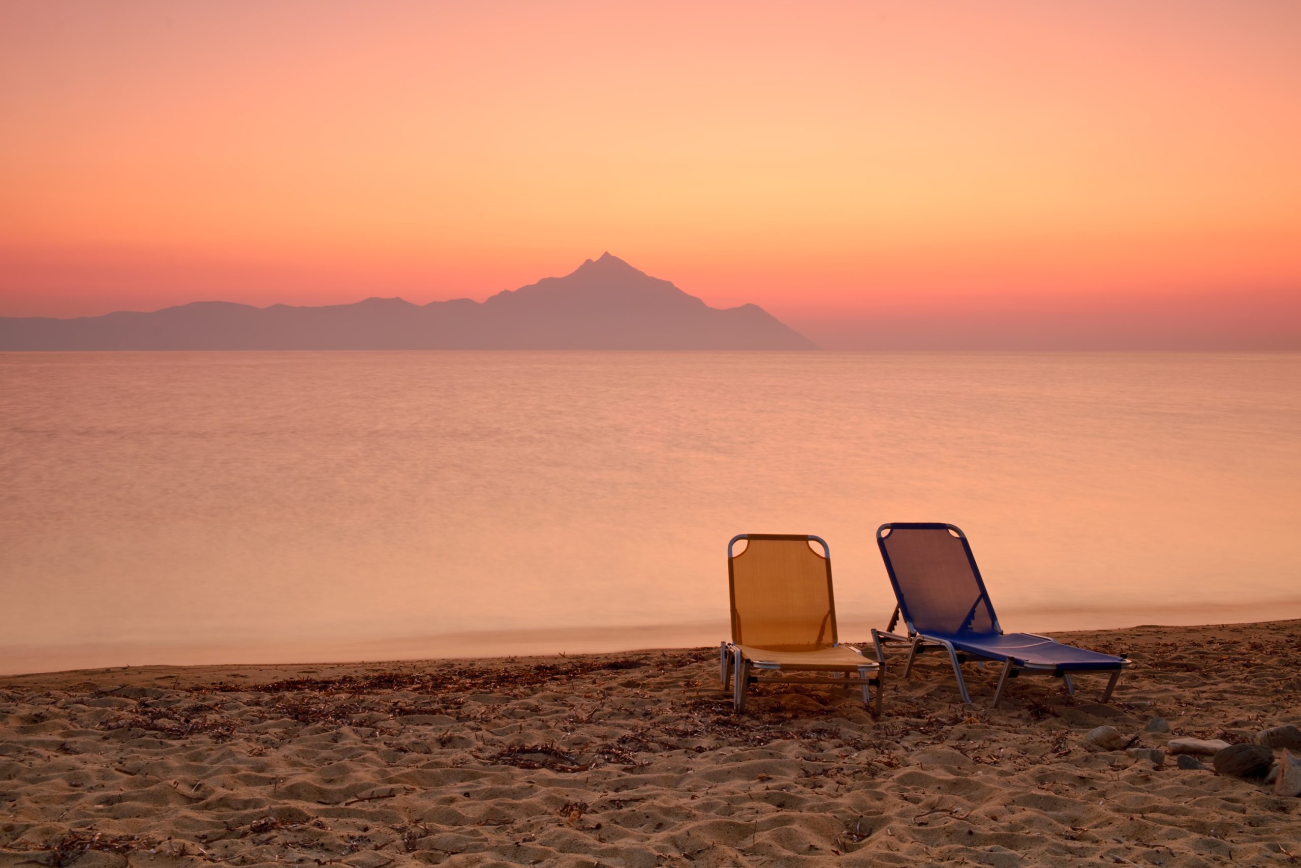 Two chairs on a sunset beach