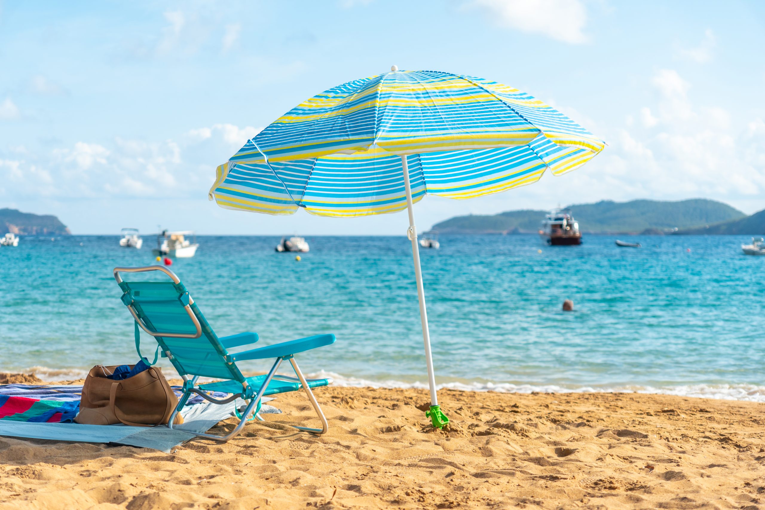 beach umbrella and chair by the sea