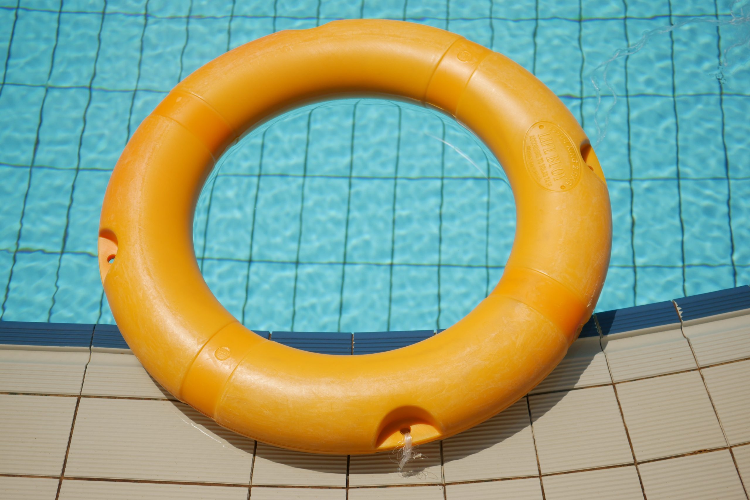 Red life buoy in swimming pool.